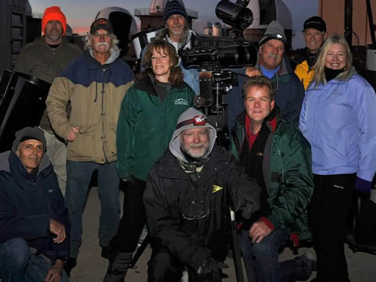 A tour group posing for a picture during their tour.
