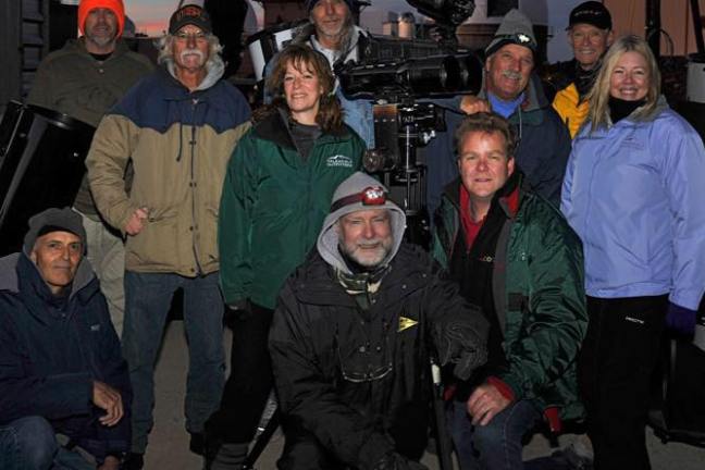 A tour group posing for a picture during their tour.